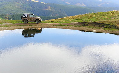 Image showing vehicle for extreme terrain near a lake