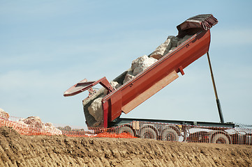 Image showing Trailer of truck unloads stones