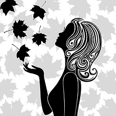 Image showing Silhouette of young woman with flying leaves