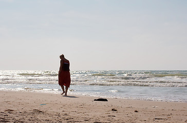 Image showing A woman walking on the beach.