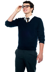 Image showing Innocent schoolboy adjusting his eyeglasses