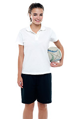 Image showing Sporty young girl holding a rugby ball