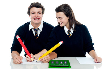 Image showing Girl making corrections on her partners examination paper