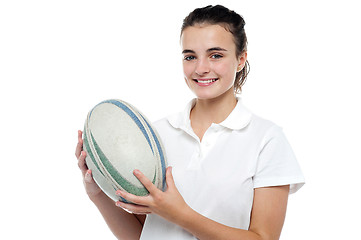 Image showing Attractive sporty girl posing with rugby ball