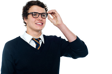 Image showing Smiling student adjusting his spectacles