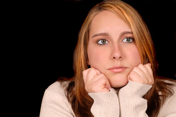 Image showing Young woman posing with her hands on her chin