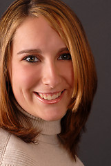 Image showing Full face view of a smiling attractive young woman