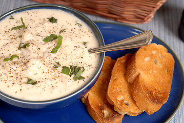 Image showing Overhead view of New England Clam Chowder in a blue bowl