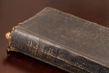 Image showing Close up view of a very old family bible resting on table