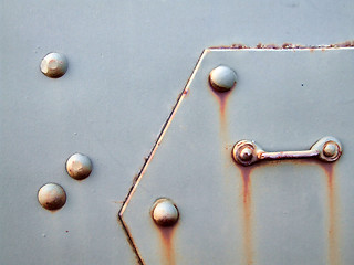 Image showing Old metal plate with bolts