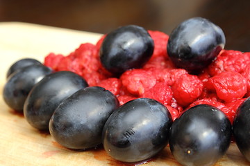 Image showing arrangement of wild raspberry and red grapes