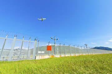 Image showing Airplane fly over grass in Hong Kong