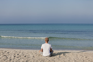 Image showing Man making yoga on the beach Sports Landscape