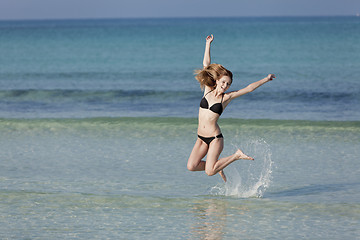 Image showing Woman with bikini jumping in the sea landscape