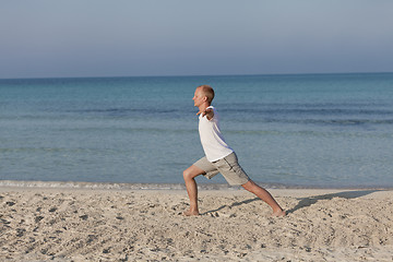 Image showing Man making yoga on the beach Sports Landscape