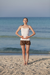 Image showing Woman doing yoga on the beach Sports Portrait
