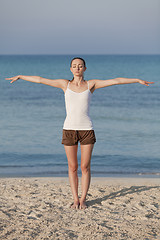 Image showing Woman doing yoga on the beach Sports Portrait