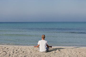 Image showing Man making yoga on the beach Sports Landscape