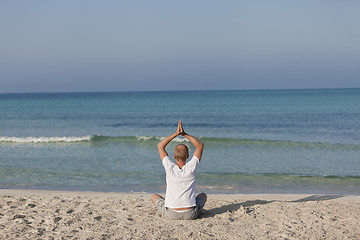 Image showing Man making yoga on the beach Sports Landscape