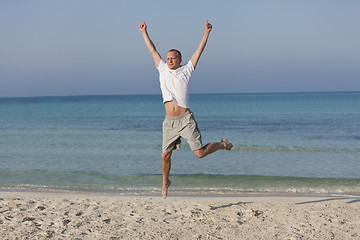 Image showing Cheerful man jumping on the beach laughing Landscape