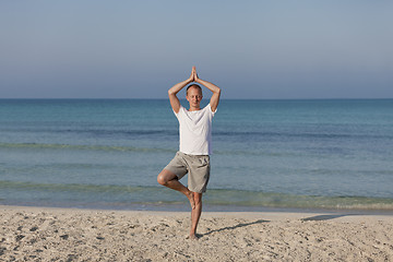 Image showing Man making yoga on the beach Sports Landscape