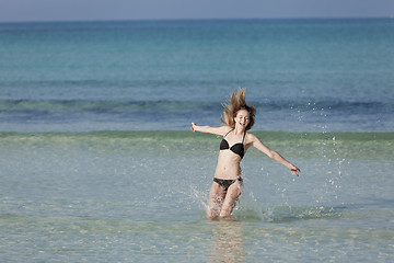 Image showing Woman with bikini jumping in the sea landscape