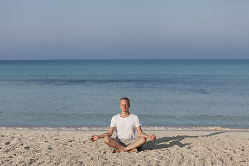 Image showing Man making yoga on the beach Sports Landscape