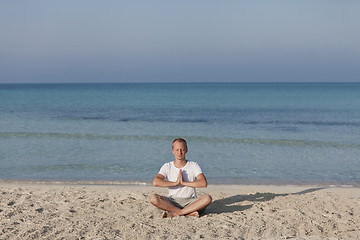 Image showing Man making yoga on the beach Sports Landscape