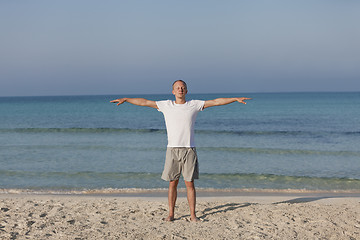 Image showing Man making yoga on the beach Sports Landscape