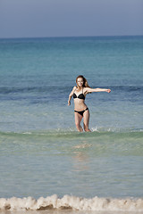 Image showing Woman with bikini in the sea jumping portrait