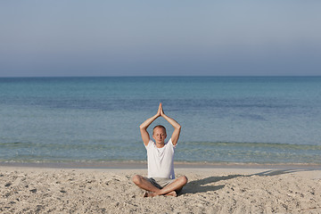 Image showing Man making yoga on the beach Sports Landscape