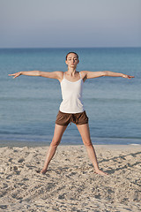 Image showing Woman doing yoga on the beach Sports Portrait