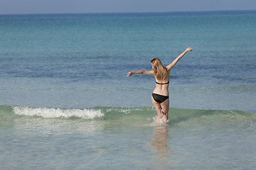 Image showing Woman with bikini in the sea jumping landscape