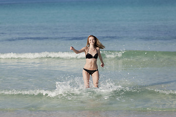 Image showing Woman with bikini in the sea jumping landscape
