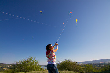 Image showing Girl with colorful kites