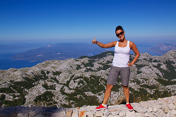 Image showing Smiling girl on hilltop