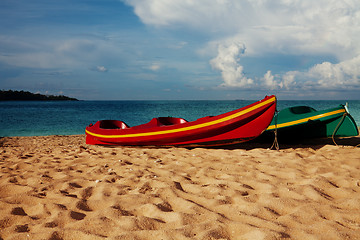 Image showing Two kayaks laying on  sand