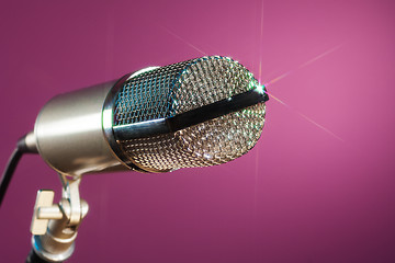 Image showing metallic microphone on pink background