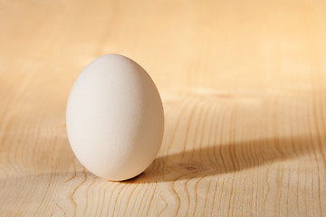 Image showing white egg on wooden table