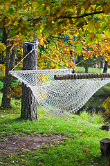 Image showing A hammock near the pond in autumn Park 