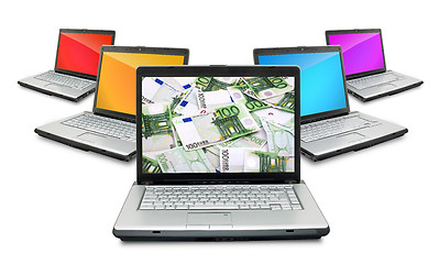 Image showing Open laptops with money