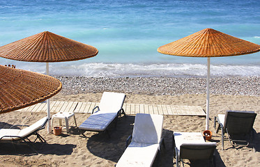 Image showing Beach chairs and umbrellas 