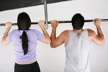 Image showing Young adult fitness woman and man preparing to do pull ups in pu