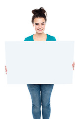 Image showing Adorable smiling teenager holding big ad board