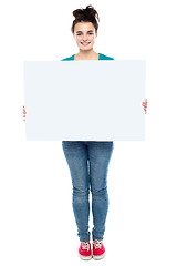 Image showing Full length portrait of stylish girl presenting banner ad
