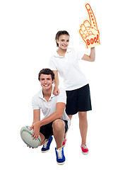 Image showing Cheerleader fan girl posing with football team player