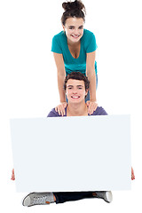 Image showing Teens advertising white blank billboard