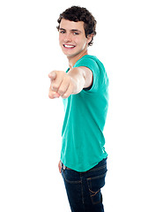 Image showing Young guy pointing you out with his stretched left arm