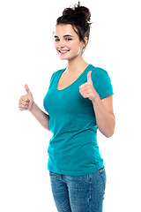 Image showing Gorgeous looking casual teenager showing double thumbs up
