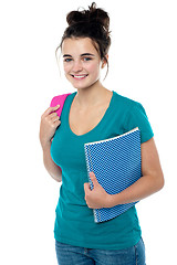Image showing College student carrying backpack and spiral notebook